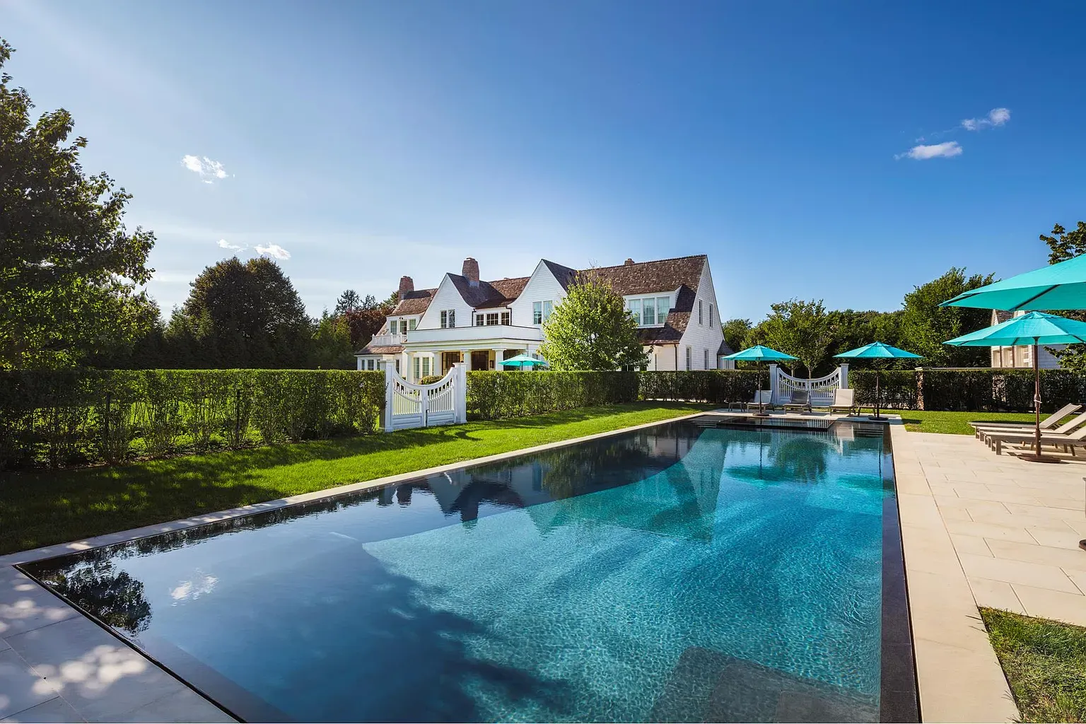 Hamptons home with swimming pool and landscaped yard